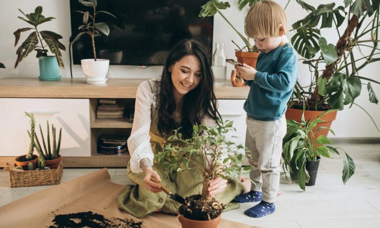 Mother with little son cultivating plants at home